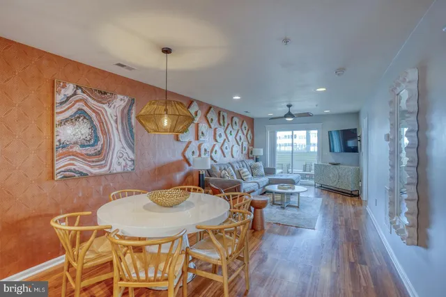 a dining room with furniture and wooden floor