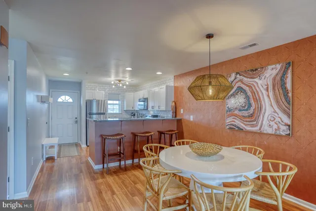 a view of a dining room with furniture and wooden floor