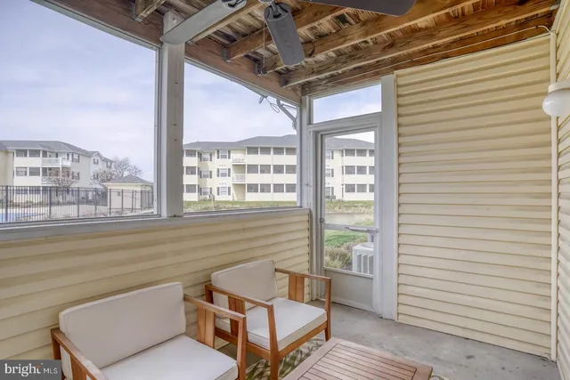 a view of balcony with a couple of white furniture