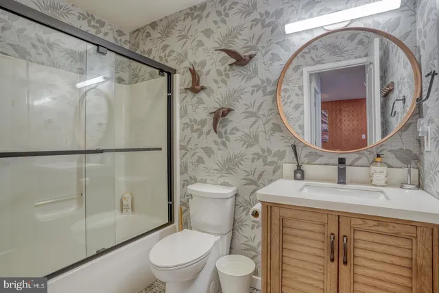 a bathroom with a sink toilet and shower