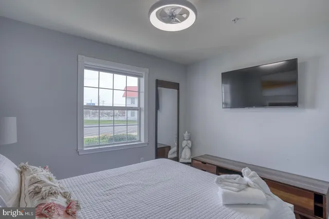 a bedroom with a bed and a flat screen tv