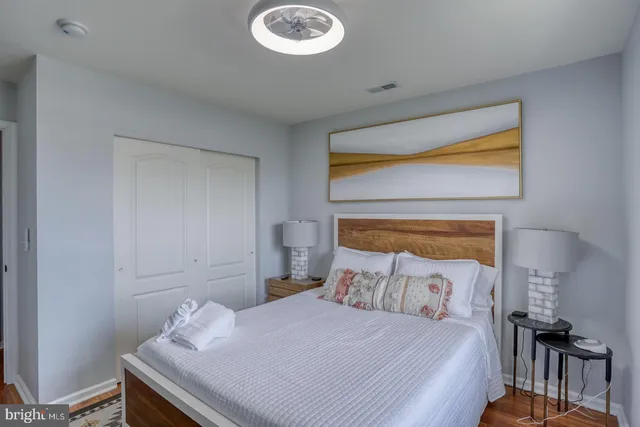 a bedroom with a bed and wooden floor