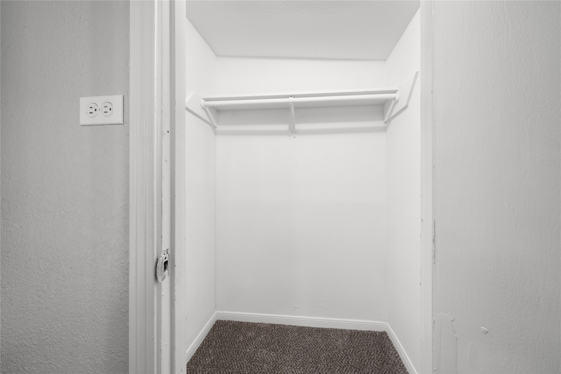 9210 Compton Street Houston, TX 77016 - Photo 24 of 50 Spacious walk-in closet with neutral tones and ample hanging space for organizing your wardrobe.