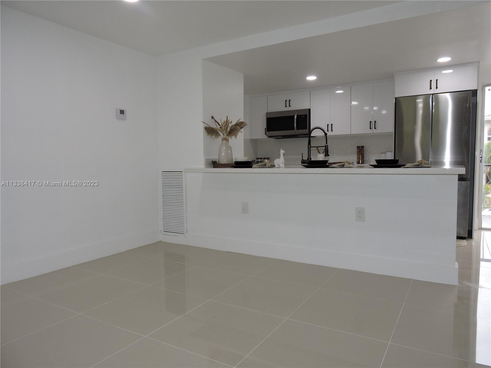 6762 Brookline Drive Hialeah, FL 33015 - Photo 19 of 25 a view of kitchen with stainless steel appliances granite countertop refrigerator sink and stove