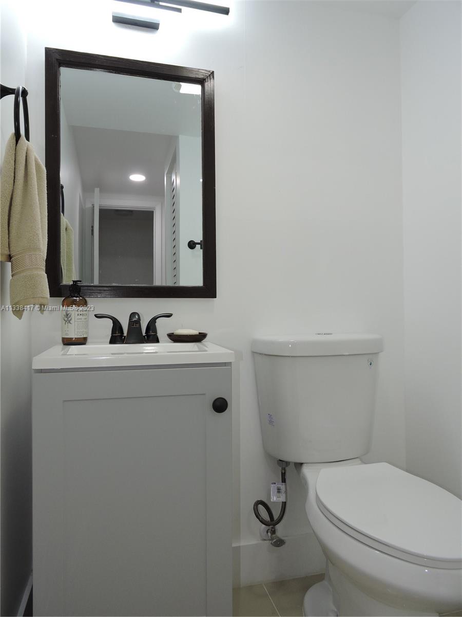 6762 Brookline Drive Hialeah, FL 33015 - Photo 25 of 25 a bathroom with a toilet sink and mirror
