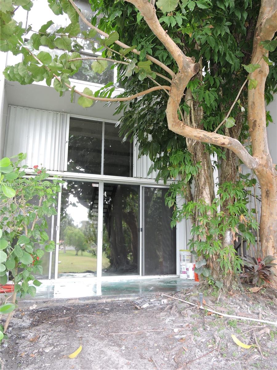 6762 Brookline Drive Hialeah, FL 33015 - Photo 7 of 25 a backyard of a house with plants and outdoor seating