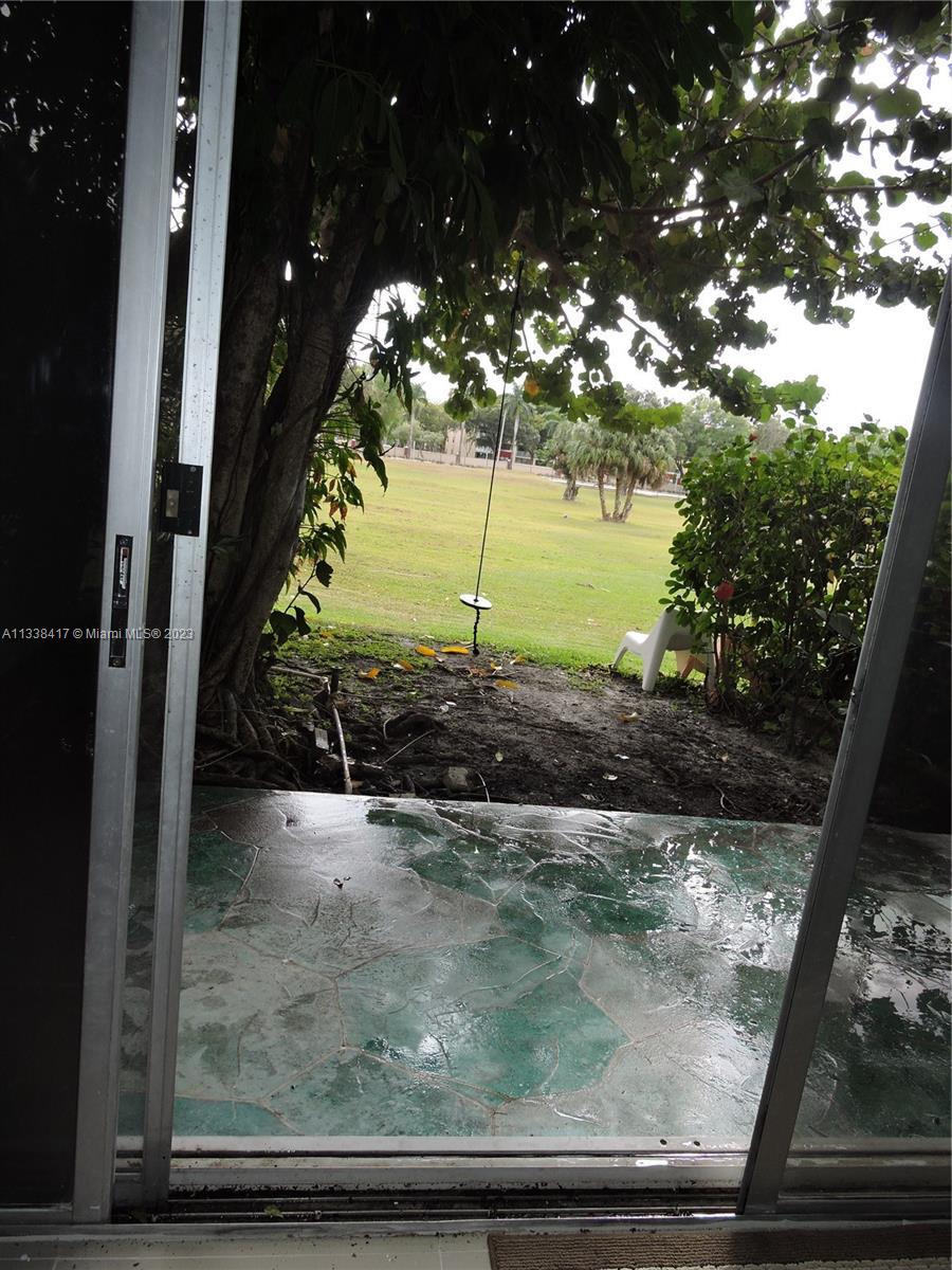 6762 Brookline Drive Hialeah, FL 33015 - Photo 8 of 25 a view of a porch with a tree