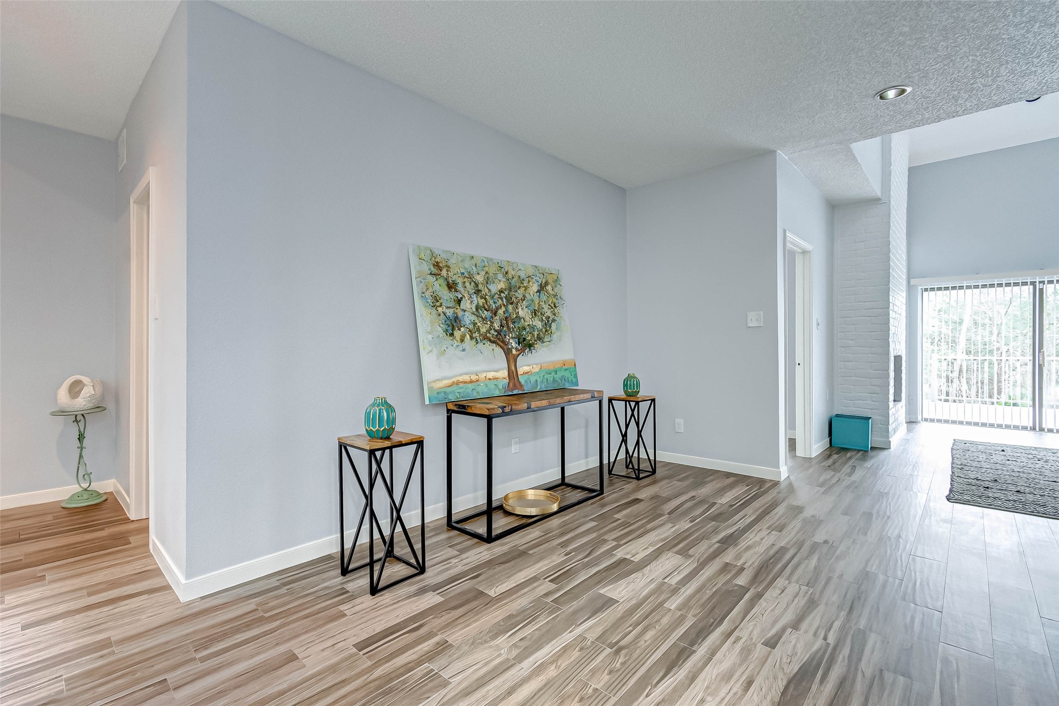 395 Rancho Bauer Drive Houston, TX 77079 - Photo 11 of 50 a view of a hallway with wooden floor and furniture