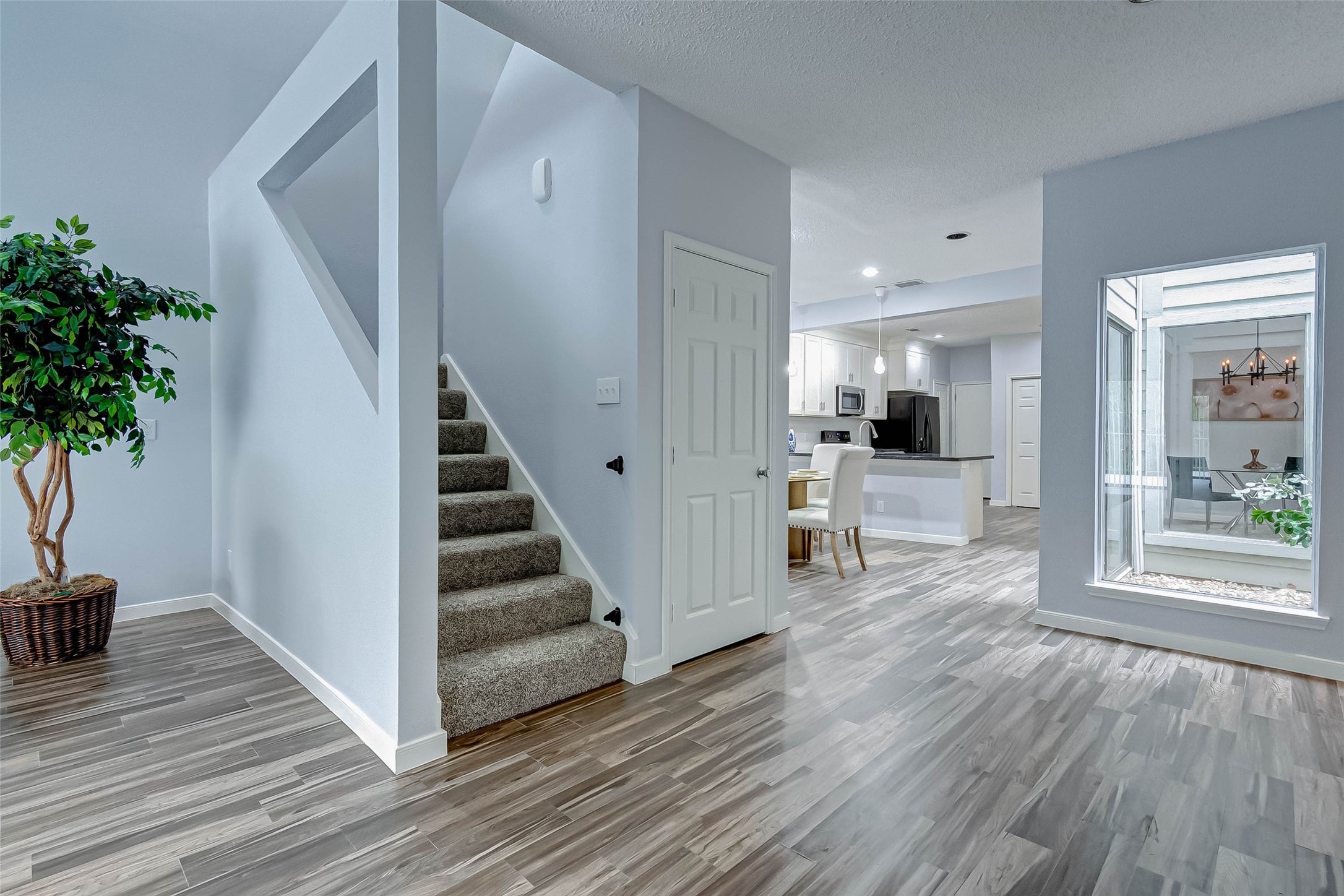 395 Rancho Bauer Drive Houston, TX 77079 - Photo 13 of 50 a view of a living room and entryway with wooden floor
