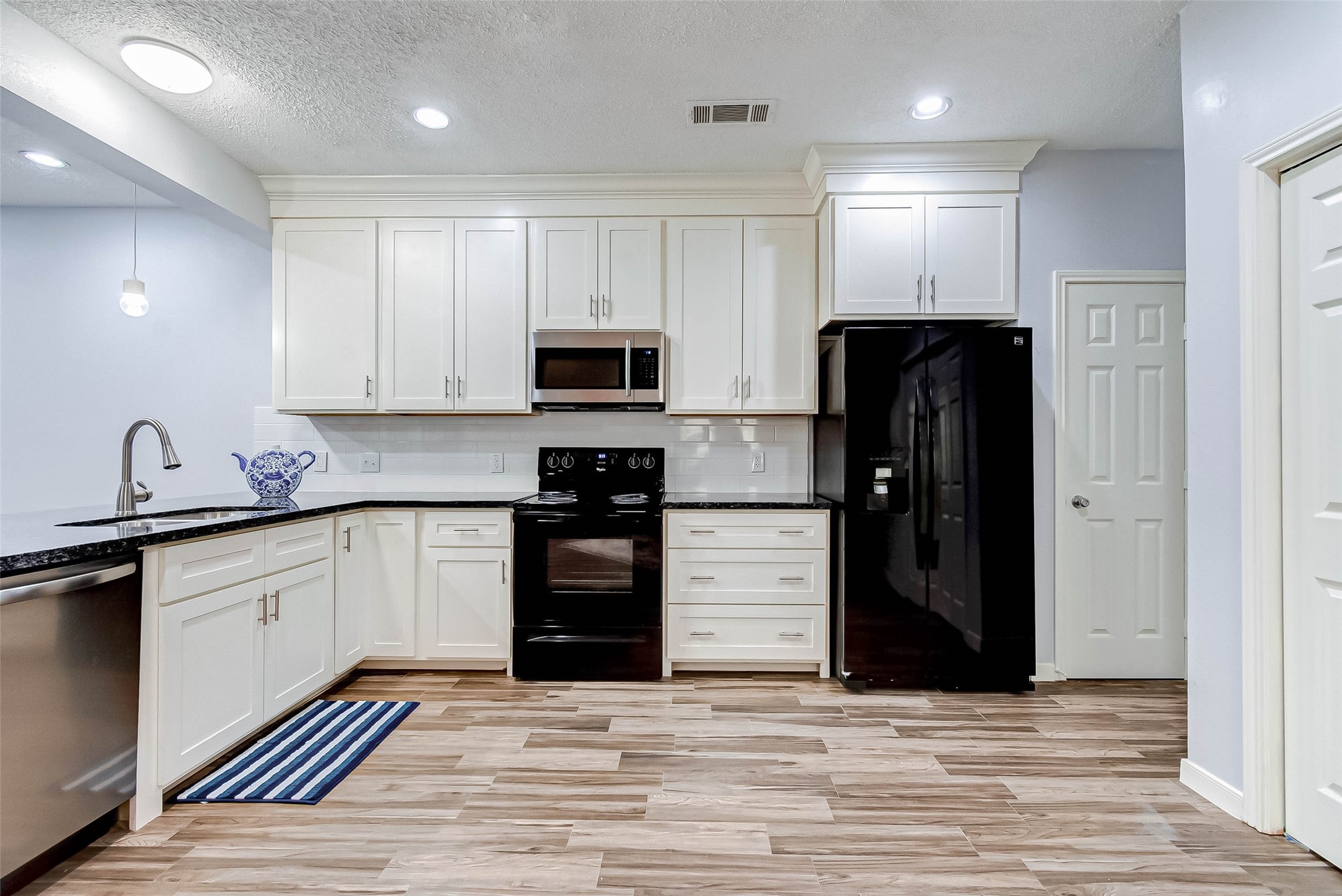 395 Rancho Bauer Drive Houston, TX 77079 - Photo 24 of 50 a kitchen with stainless steel appliances granite countertop a refrigerator and a stove top oven