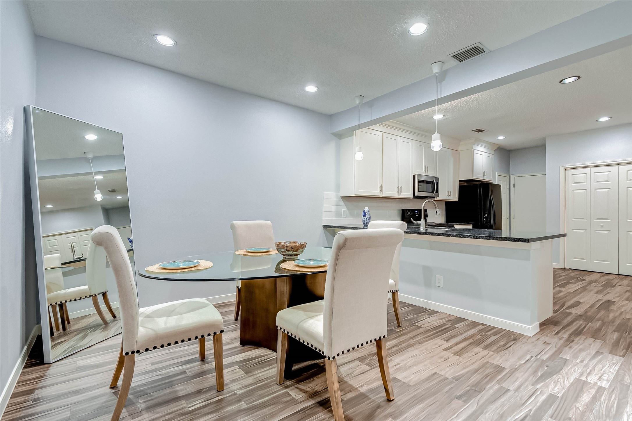 395 Rancho Bauer Drive Houston, TX 77079 - Photo 29 of 50 a kitchen with a dining table chairs and wooden floor