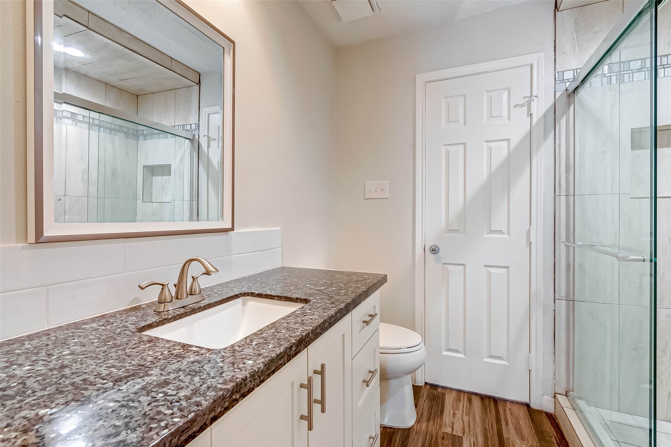 395 Rancho Bauer Drive Houston, TX 77079 - Photo 34 of 50 a bathroom with a granite countertop sink and a mirror