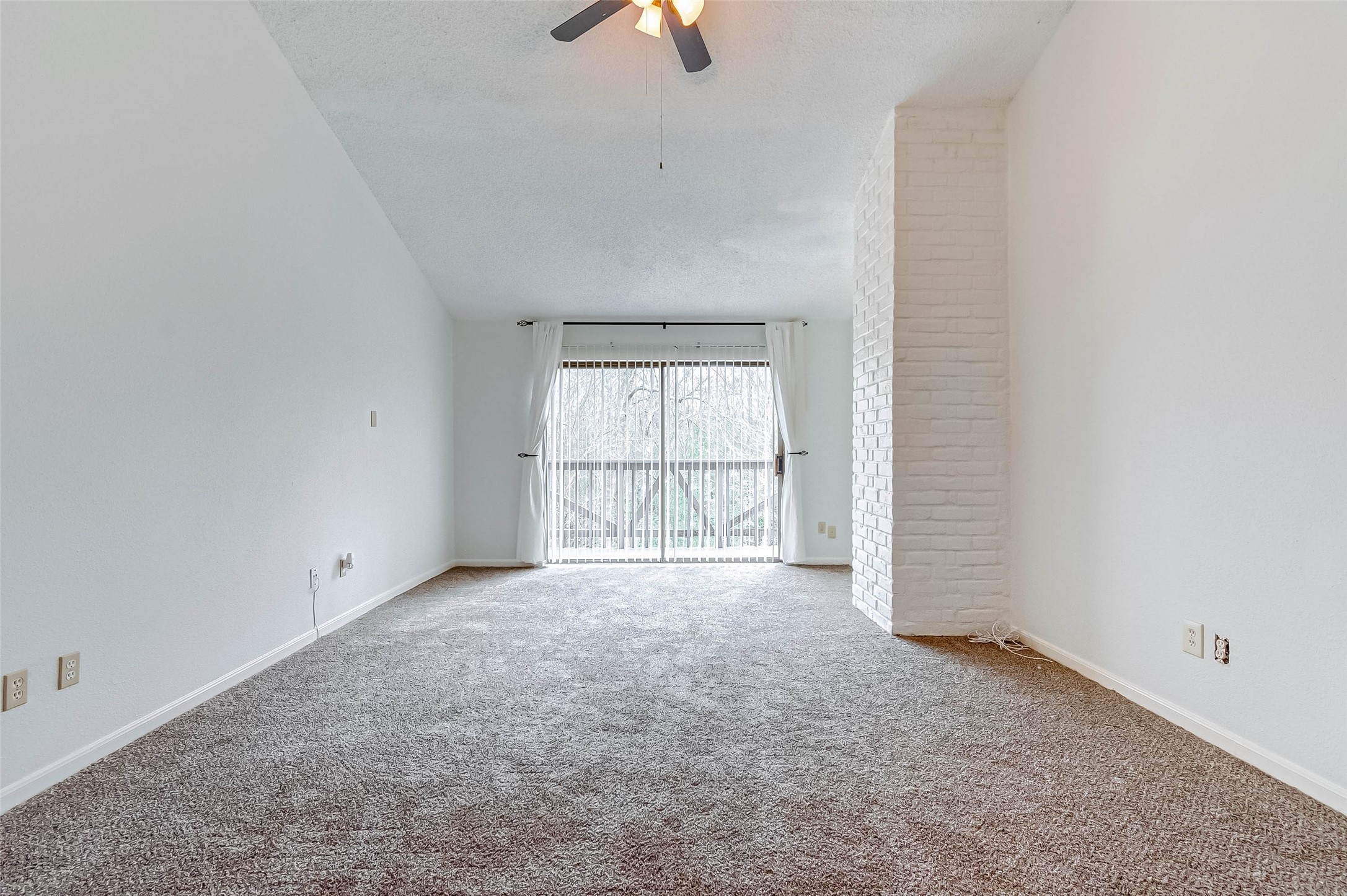 395 Rancho Bauer Drive Houston, TX 77079 - Photo 38 of 50 an empty room with chandelier fan and windows