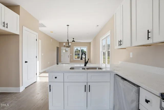 a kitchen with kitchen island sink and refrigerator