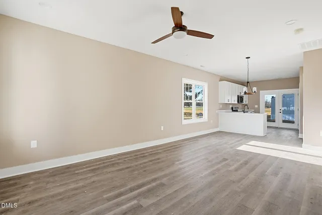 a view of a kitchen with a sink hardwood floor and a window