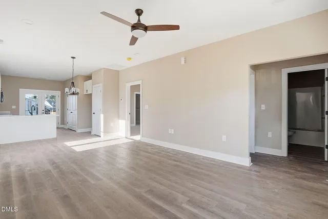 a view of a big room with wooden floor and windows