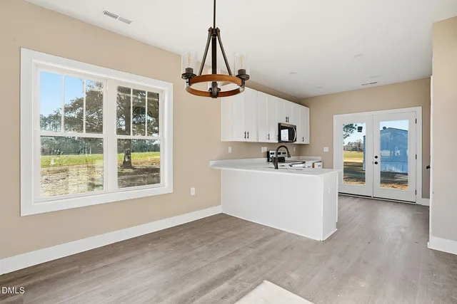 a view of kitchen with granite countertop cabinets a sink and appliances