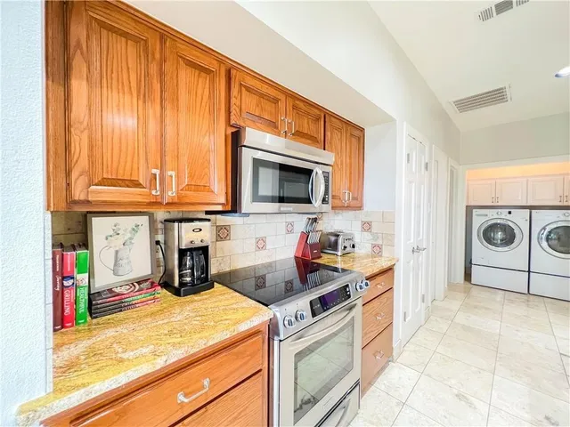 a kitchen with stainless steel appliances granite countertop a stove and a sink