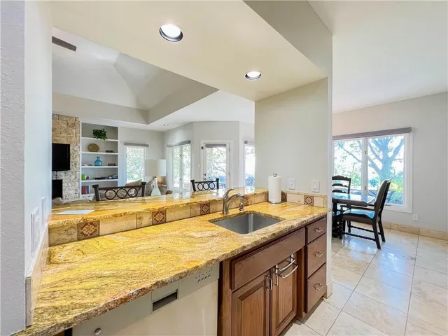 a spacious bathroom with a granite countertop sink and a large mirror