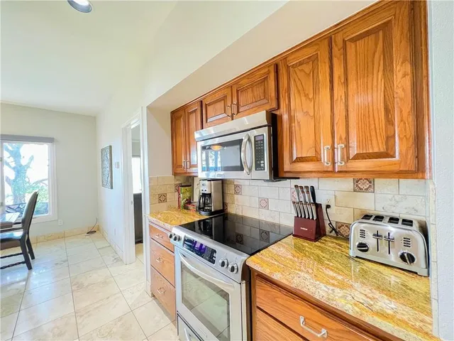 a kitchen that has a sink and a stove in it