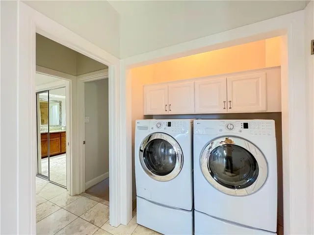 a utility room with sink dryer and washer