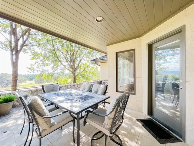 a view of a patio with a table and chairs