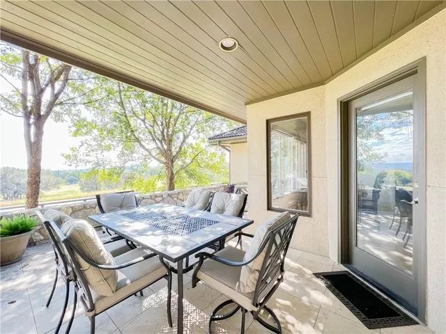 a view of a patio with a table and chairs