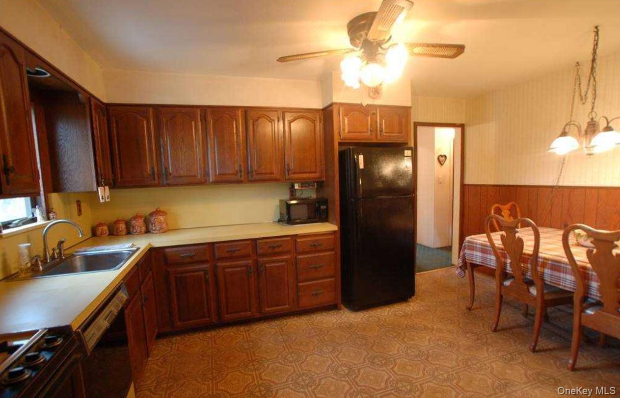 7 Miles Avenue Albertson, NY 11507 - Photo 2 of 8 a kitchen with stainless steel appliances granite countertop a refrigerator a sink a stove and island