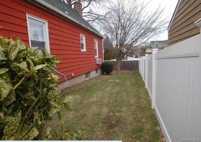 a view of a backyard with a large tree