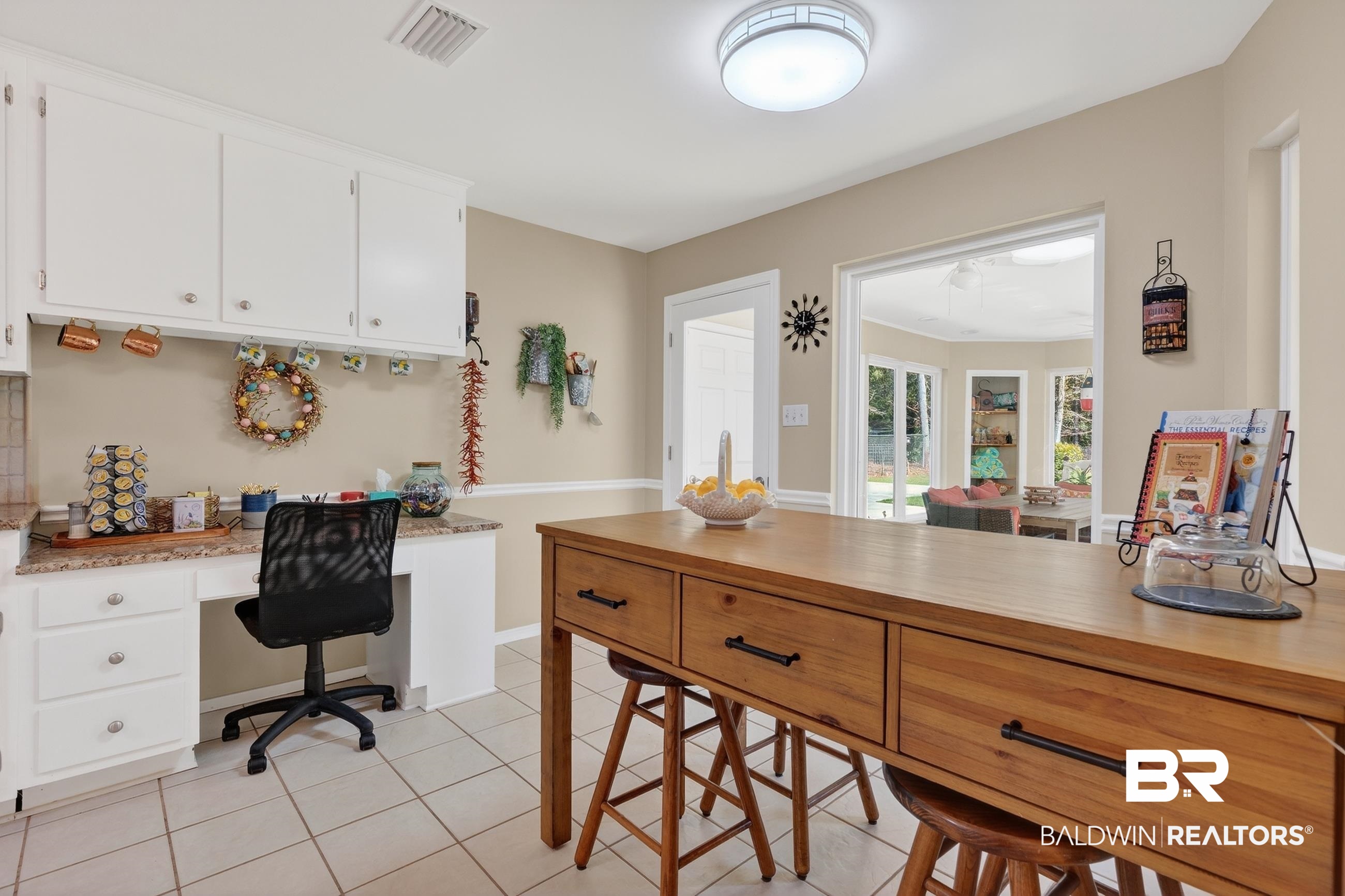1271 Spring Valley Drive South Mobile, AL 36693 - Photo 21 of 56 Kitchen featuring built in desk, light tile patterned floors, white cabinetry, and a peninsula