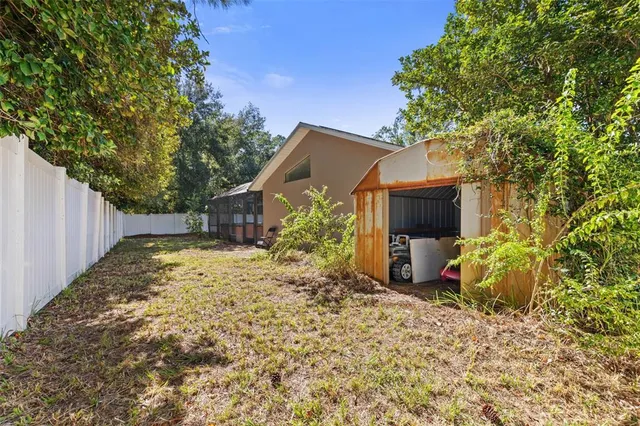 an aerial view of residential house with outdoor space and trees