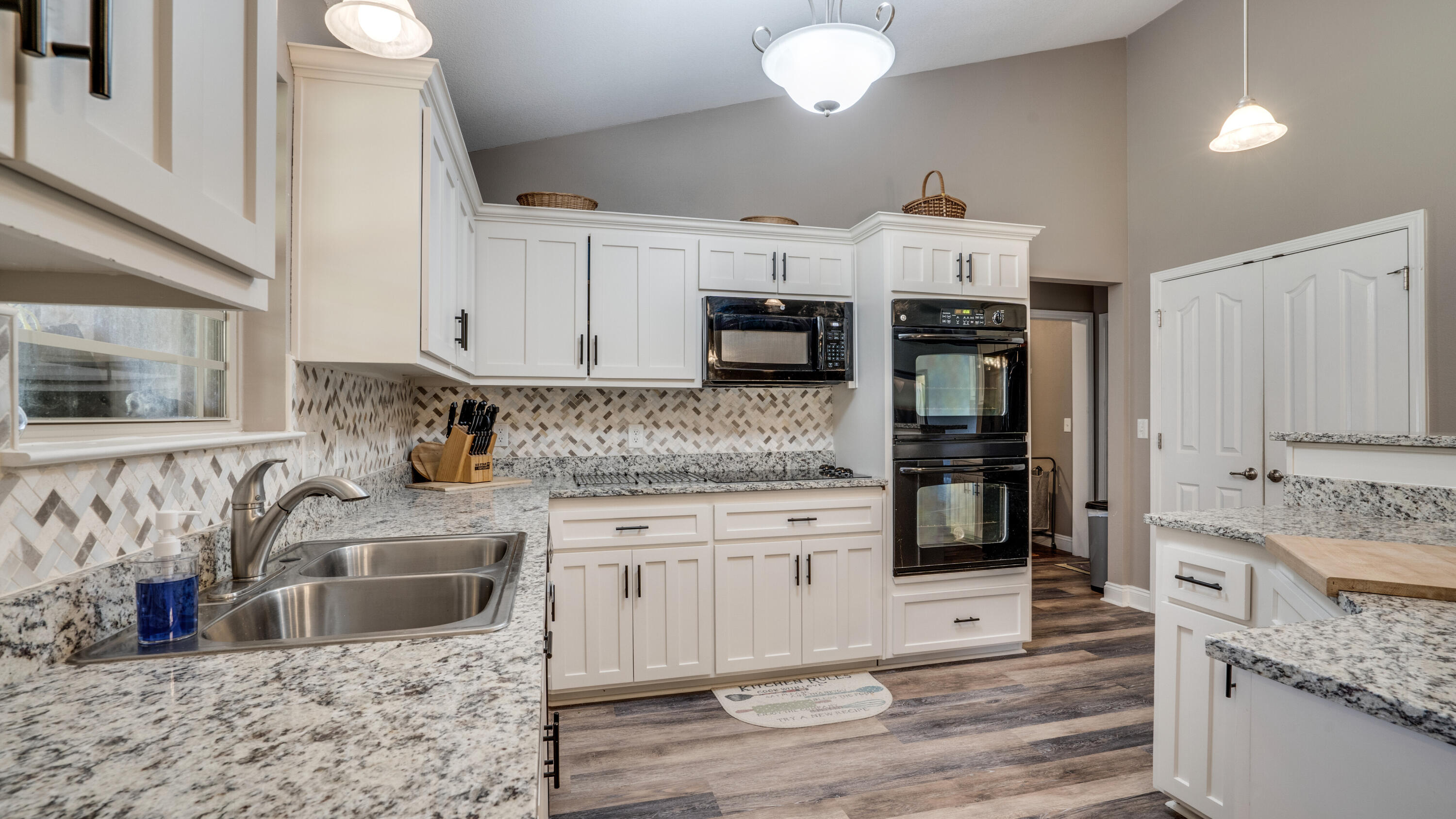 9606 South Trace Road Milton, FL 32583 - Photo 14 of 48 a kitchen with stainless steel appliances granite countertop a stove a sink and a microwave