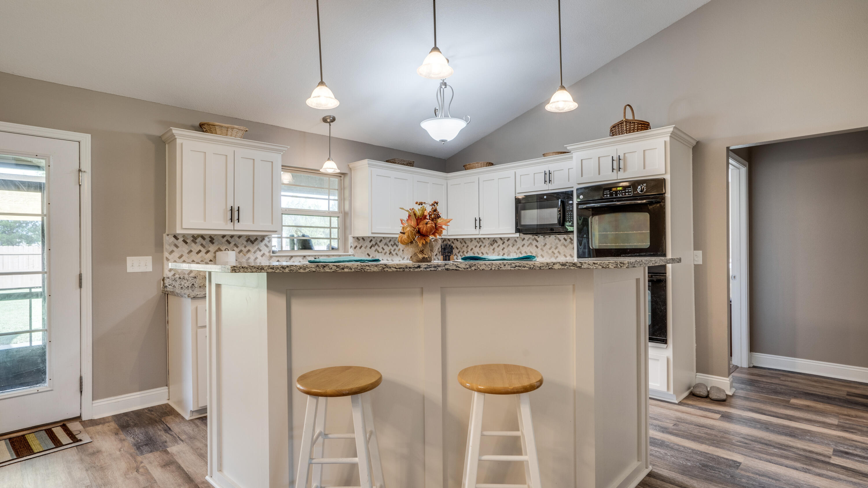 9606 South Trace Road Milton, FL 32583 - Photo 15 of 48 a kitchen with stainless steel appliances granite countertop a refrigerator a stove a sink and a microwave