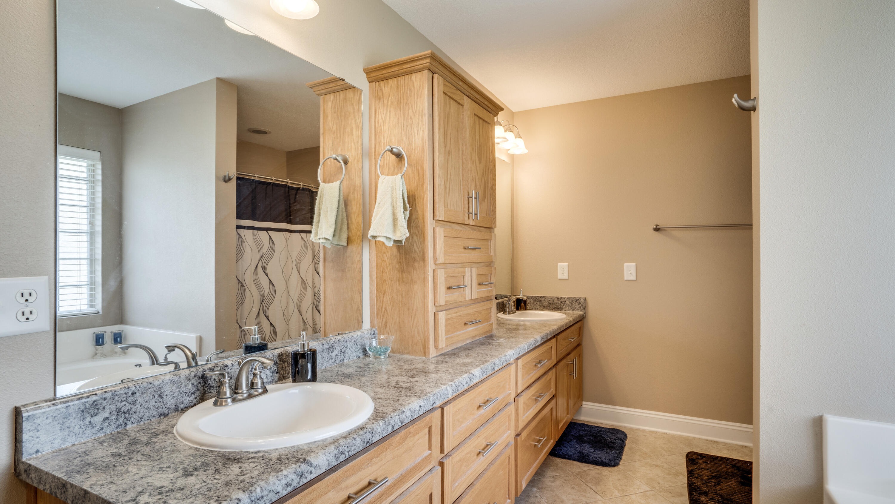 9606 South Trace Road Milton, FL 32583 - Photo 23 of 48 a bathroom with double vanity sink and a mirror