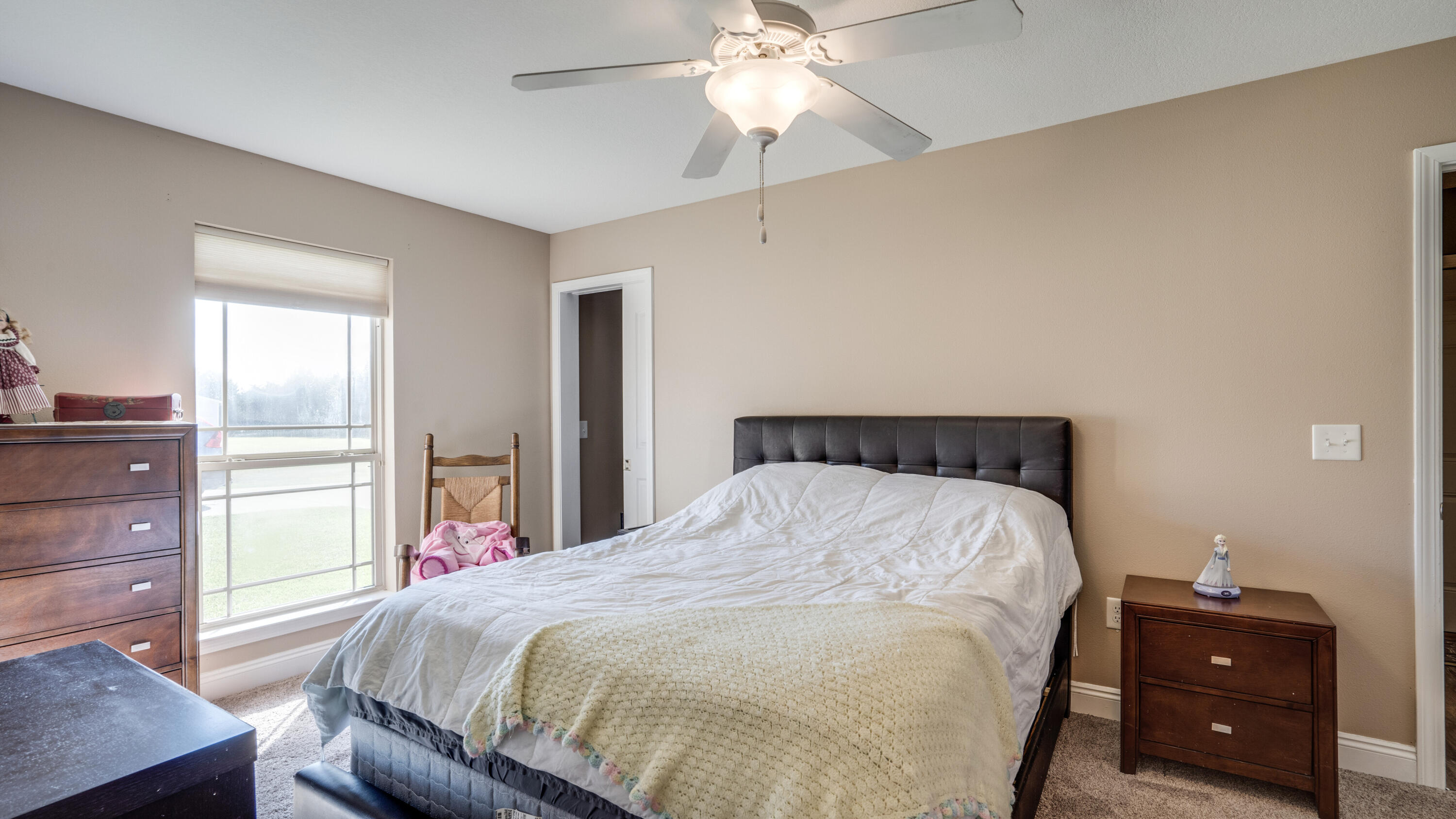 9606 South Trace Road Milton, FL 32583 - Photo 25 of 48 a bedroom with a bed and a chandelier