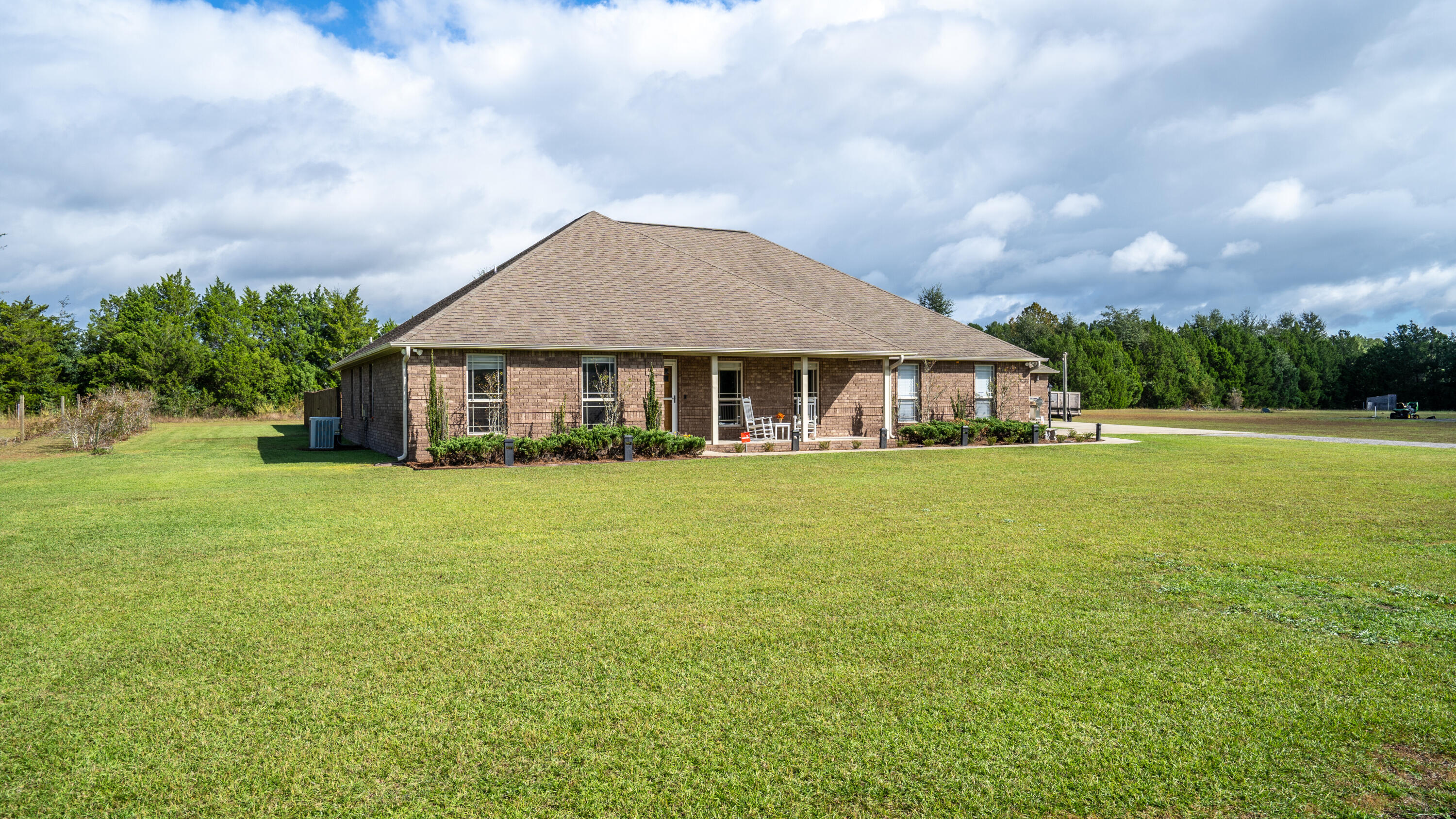 9606 South Trace Road Milton, FL 32583 - Photo 3 of 48 a front view of a house with a garden