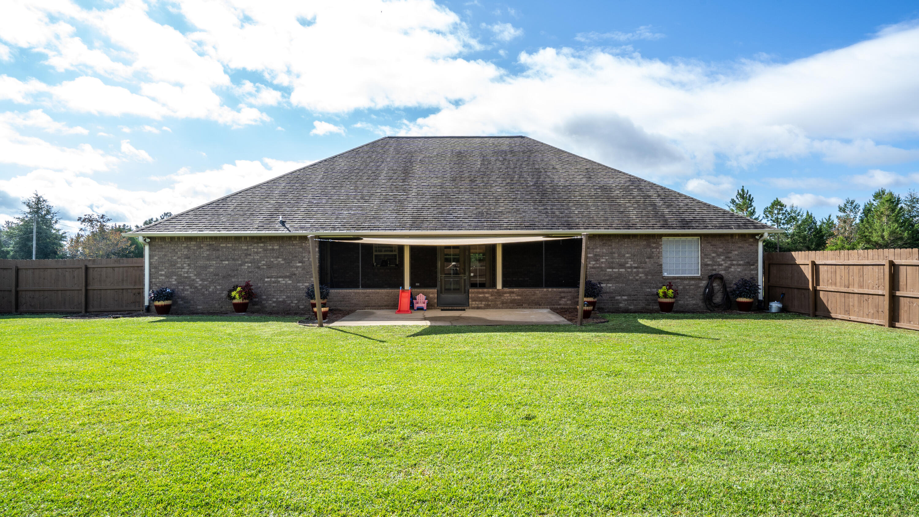 9606 South Trace Road Milton, FL 32583 - Photo 35 of 48 a view of a house with a yard and sitting area