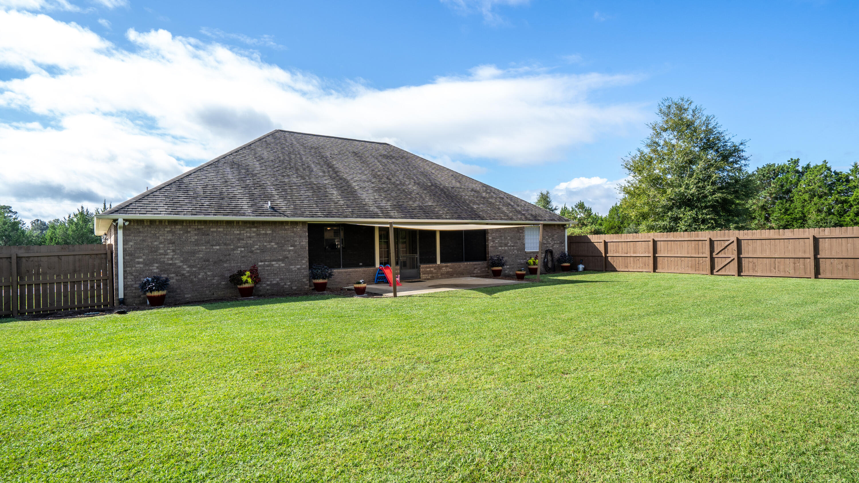 9606 South Trace Road Milton, FL 32583 - Photo 36 of 48 a view of a house with backyard and garden