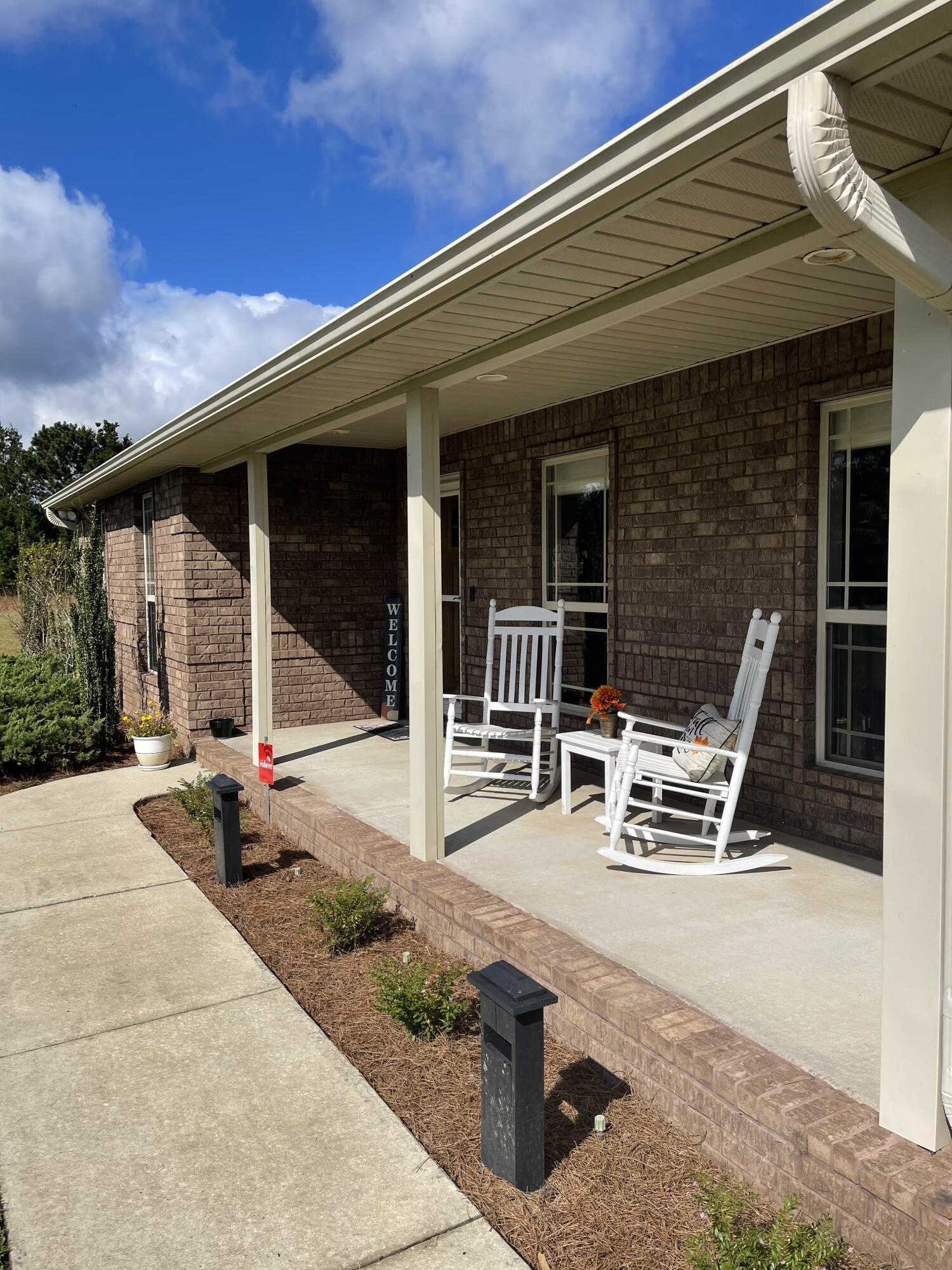9606 South Trace Road Milton, FL 32583 - Photo 5 of 48 a bench sitting in front of a building