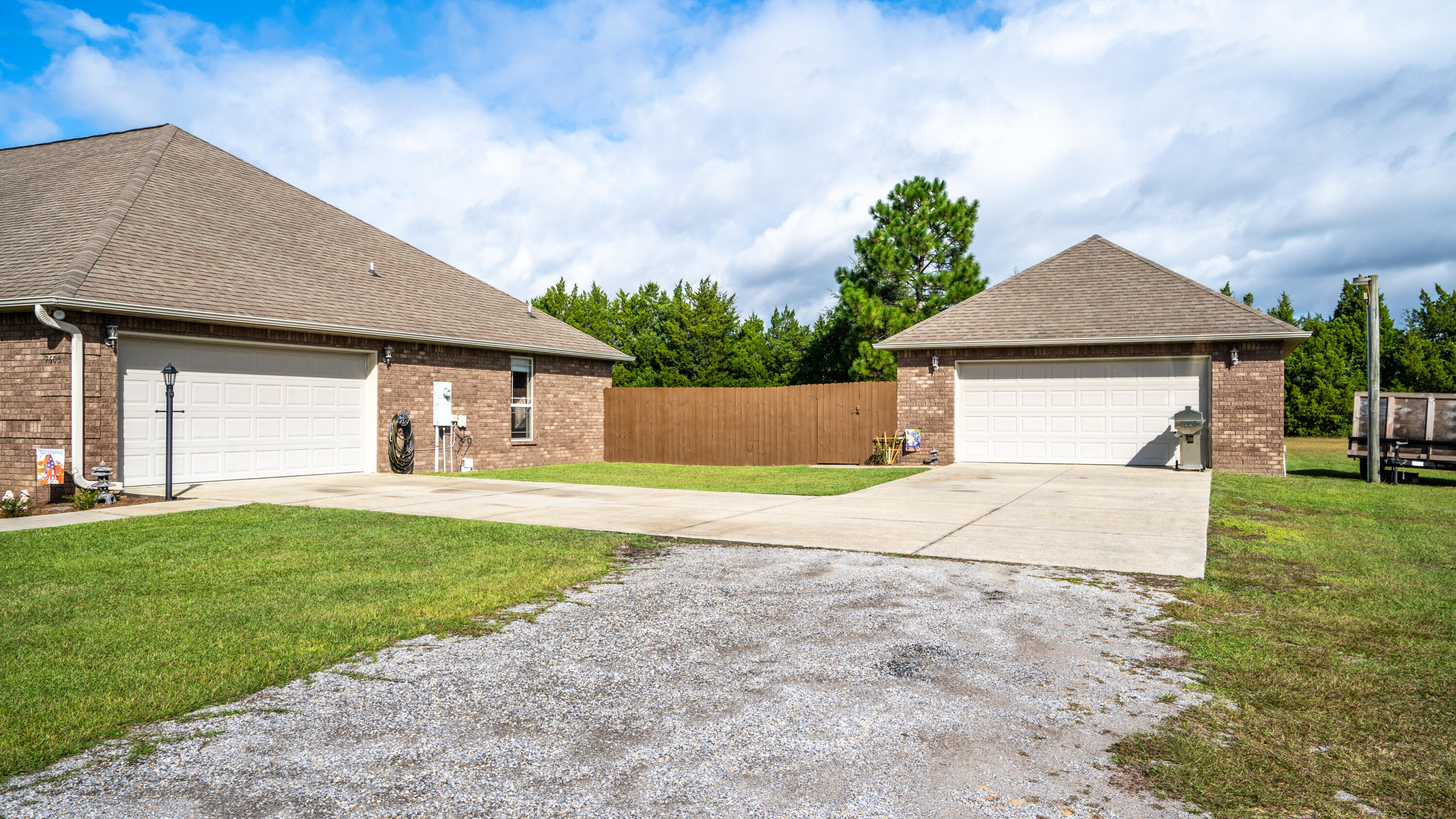 9606 South Trace Road Milton, FL 32583 - Photo 6 of 48 a front view of a house with a yard and garage