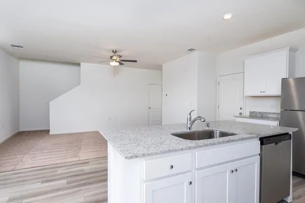 a kitchen with a sink and cabinets