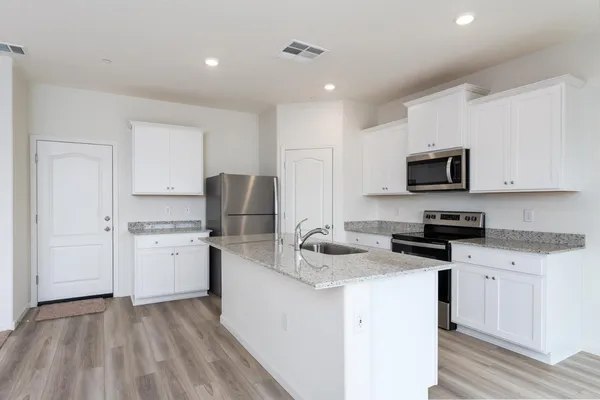 a kitchen with a sink stove and refrigerator