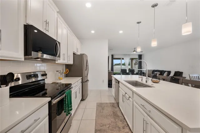 a kitchen with a sink a stove and microwave
