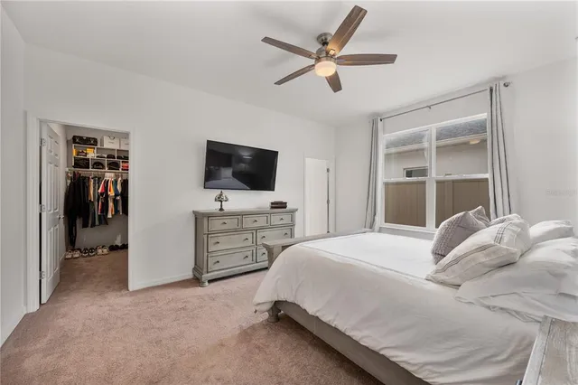 a spacious bedroom with a bed and a chandelier