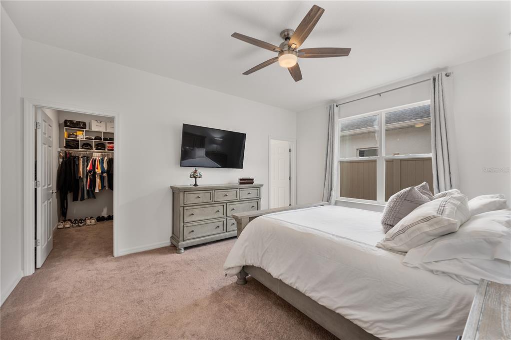 2887 Parkfield Road St. Cloud, FL 34772 - Photo 20 of 51 a bedroom with a bed and a flat screen tv