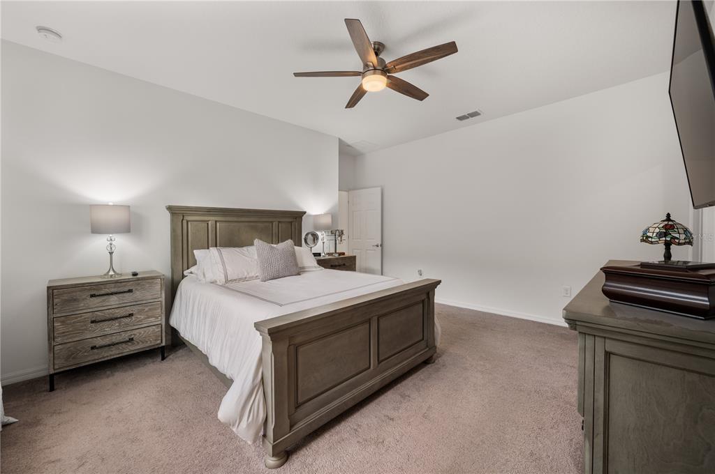 2887 Parkfield Road St. Cloud, FL 34772 - Photo 22 of 51 a bedroom with a bed and a ceiling fan