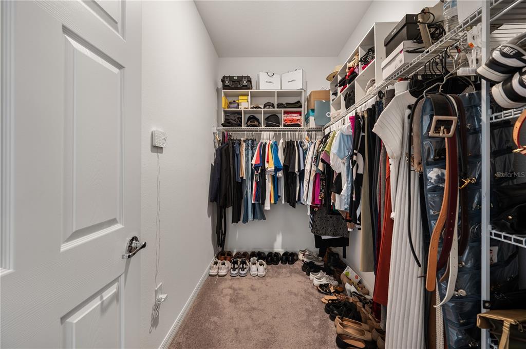 2887 Parkfield Road St. Cloud, FL 34772 - Photo 23 of 51 a view of walk in closet with clothes