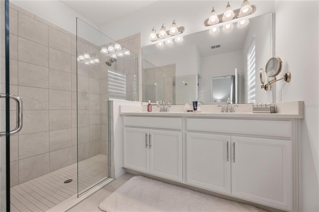 2887 Parkfield Road St. Cloud, FL 34772 - Photo 25 of 51 a bathroom with a double vanity sink mirror and shower