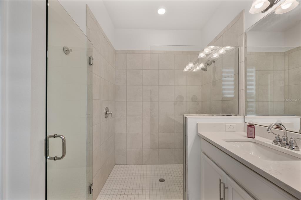 2887 Parkfield Road St. Cloud, FL 34772 - Photo 26 of 51 a bathroom with a shower sink and mirror