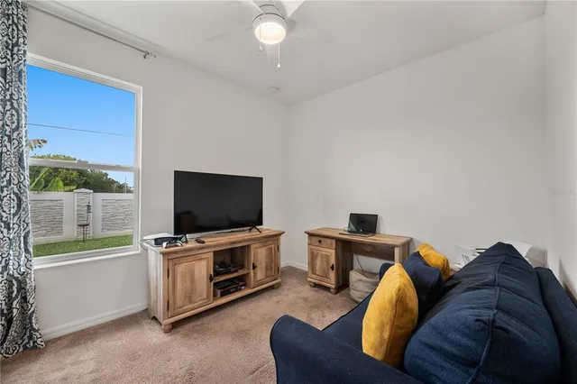 a living room with furniture and a air conditioner vent